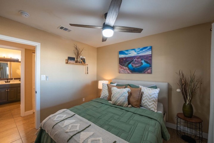 The Green Room, lush green bedding, photography on the wall is of the famous Horseshoe Canyon on the Colorado River.